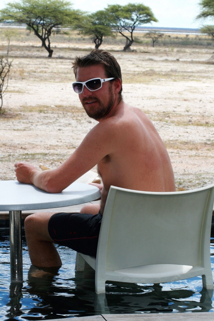 Ed enjoying a good read with an amazing view of the wildlife at Onguma Fort, Etosha