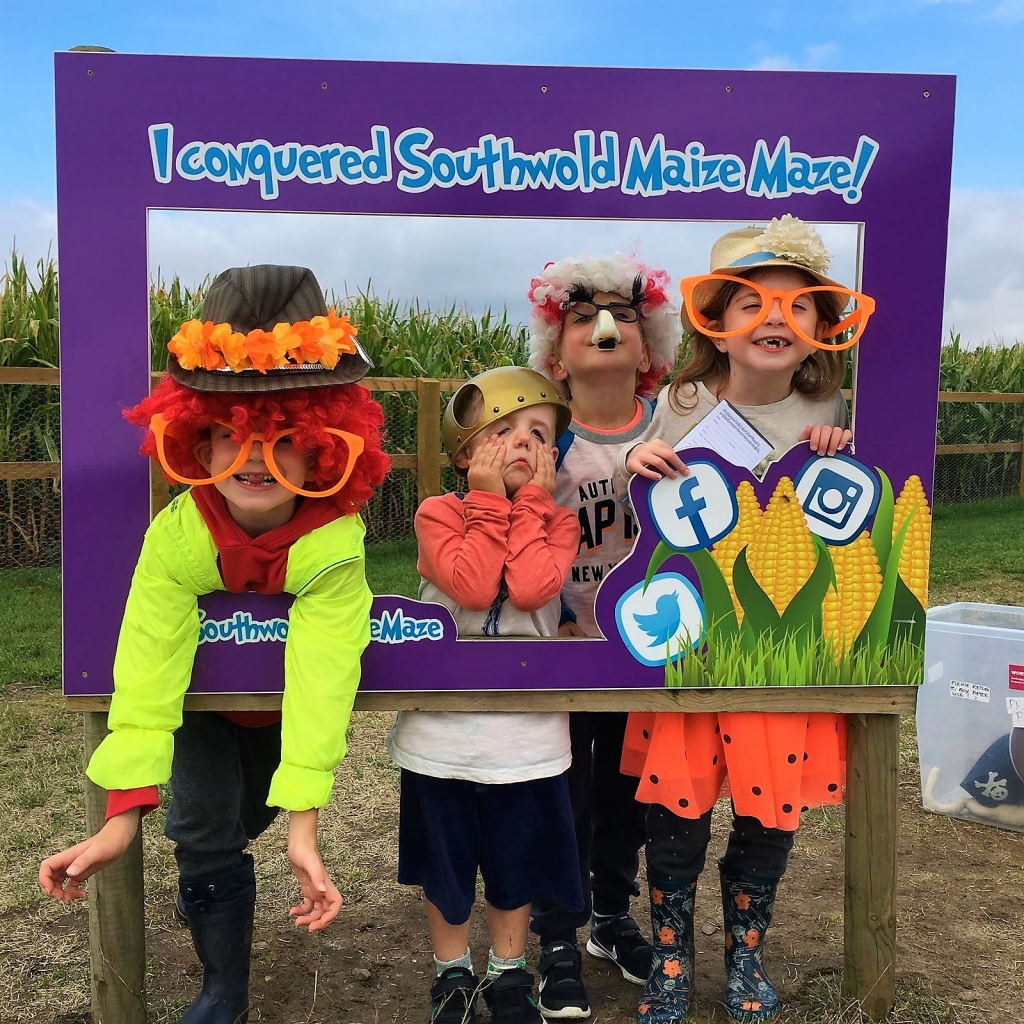 The kids messing around with the dressing up box at Southwold Maize Maze