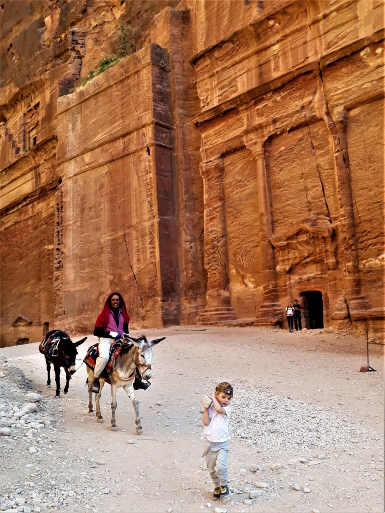 Visiting Jordan with kids playing with rocks at Petra