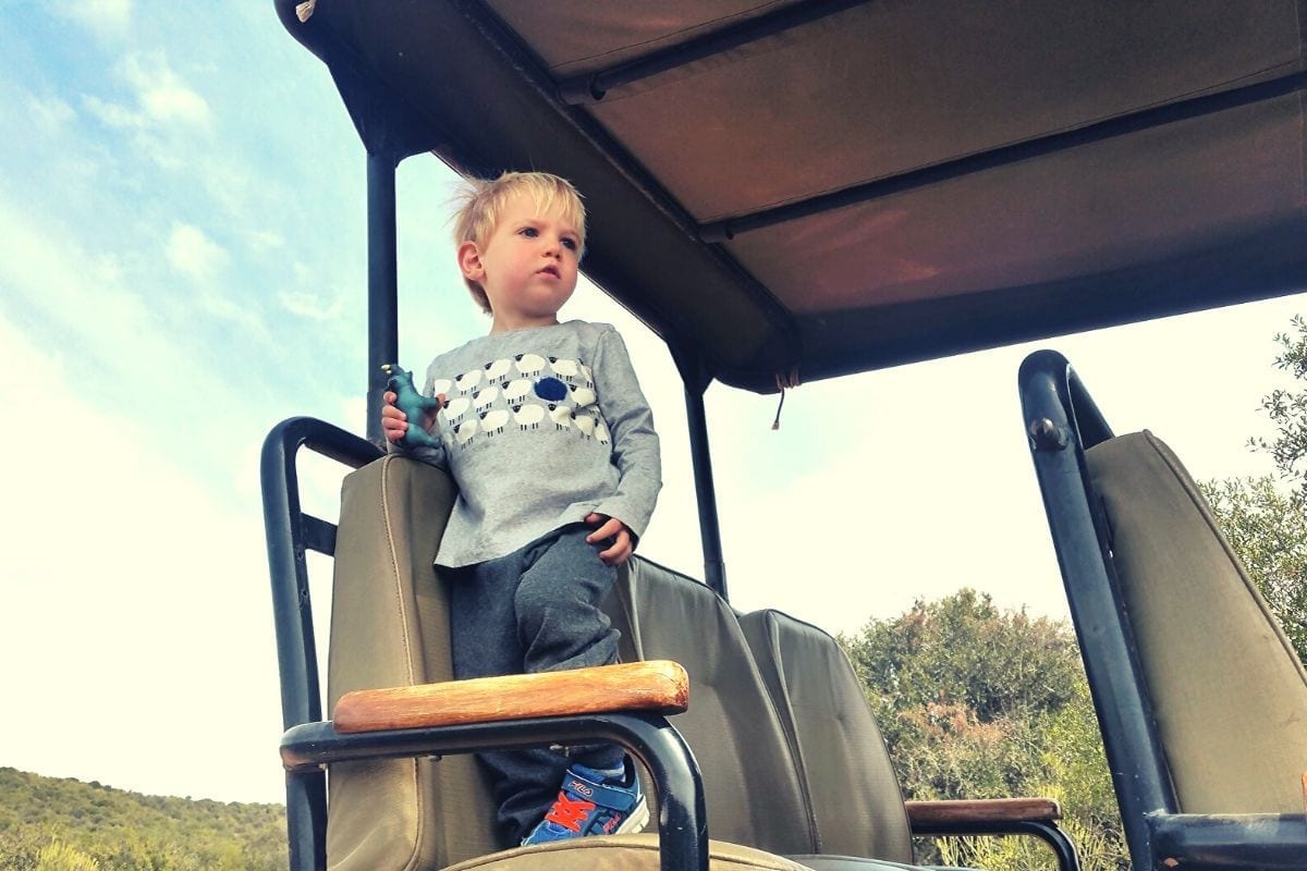 Two year old on a safari jeep while taking an African safari with kids 