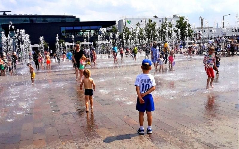 Cooling off in the fountains at Granary Square in London.
