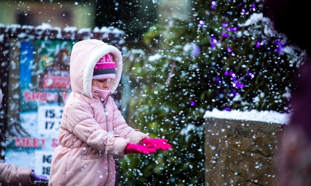 Girl playing in the snow at Santa Sleepover in Chessington World of Adventures 