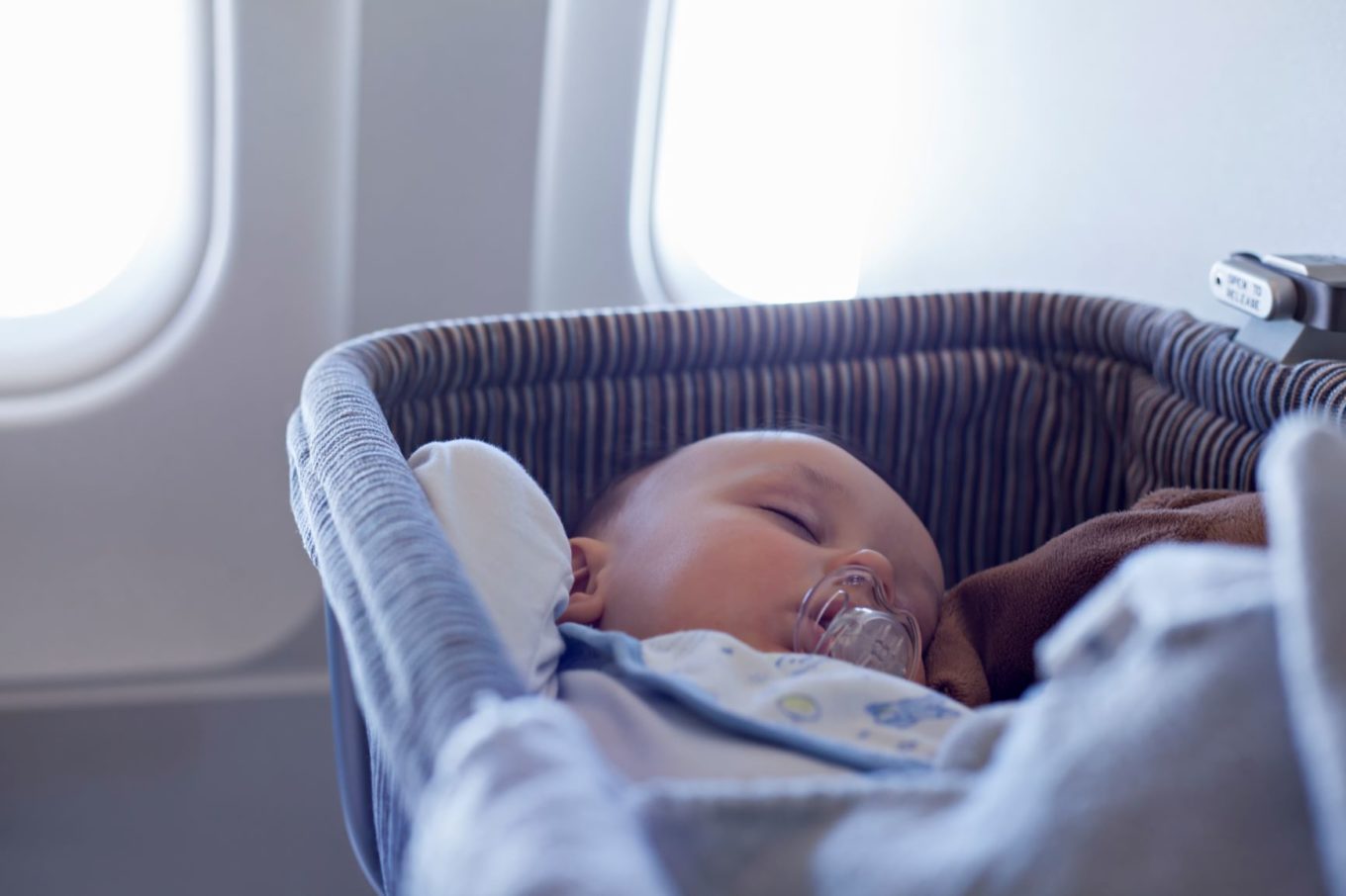 Baby in a bassinet on a plane