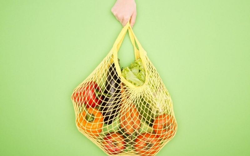 String bag with loose fruit and vegetables