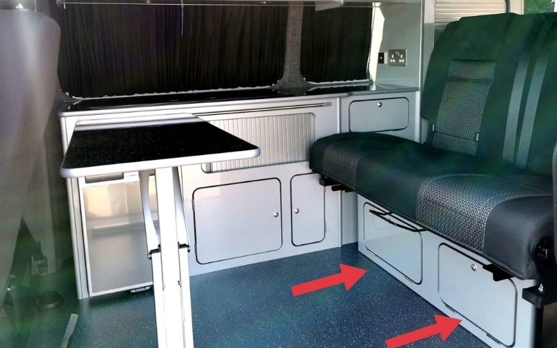 Cupboards under the back seats in a VW campervan.