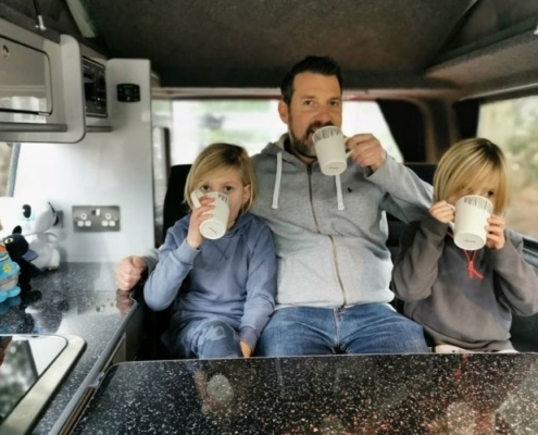 Drinking hot chocolate in a campervan.