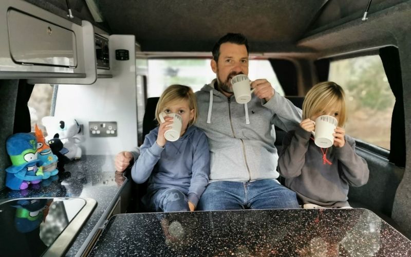 Drinking hot chocolate in a campervan.