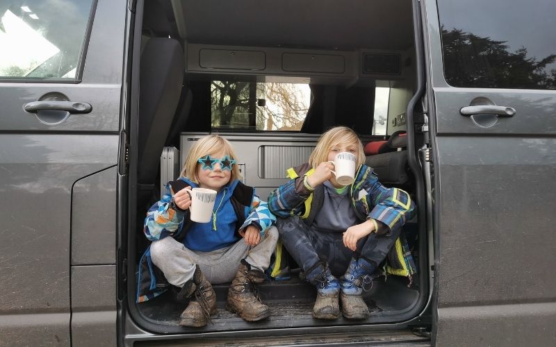 Enjoying a well deserved hot chocolate in the campervan with kids after a long winter walk.