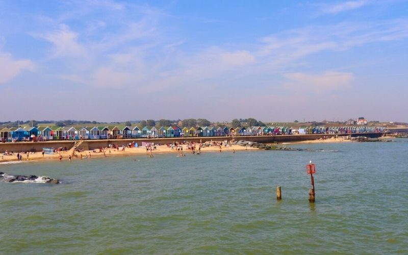 Southwold Beach backed by colourful beach huts.