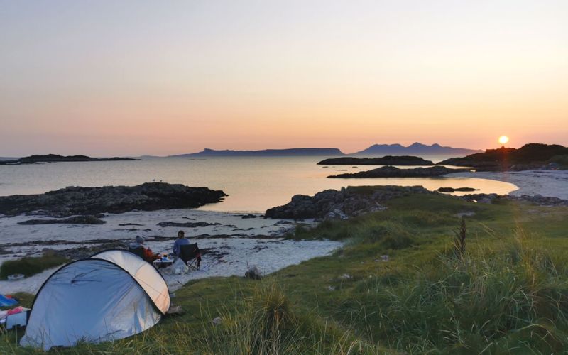 Tent on a Scottish beach at sunset.