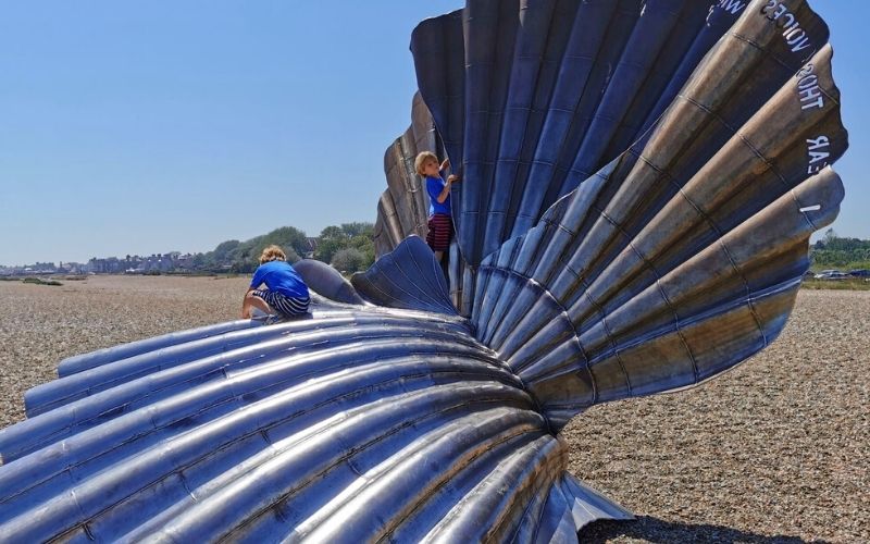 Kids playing on The Scallop on Aldeburgh Beach.