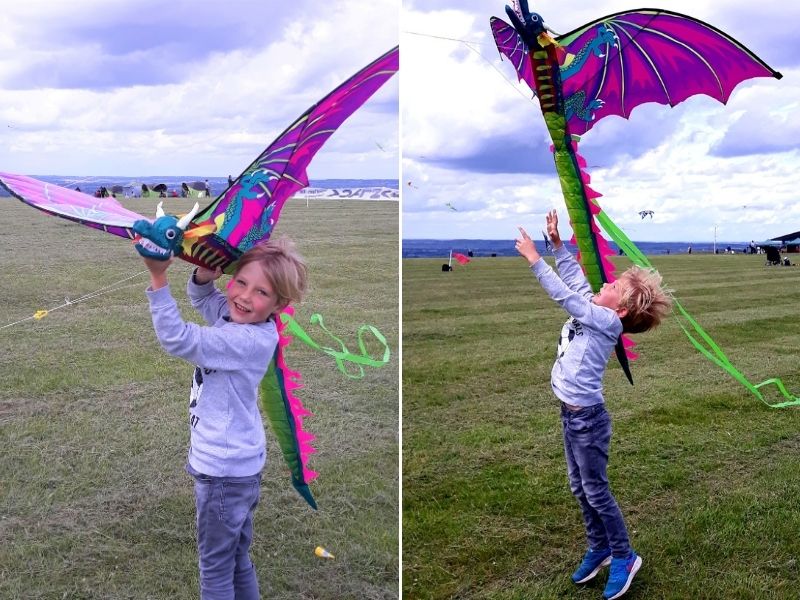 Little boy holding a colourful dragon kite. Flying a kite is one of our favourite things to do with kids in Spring.