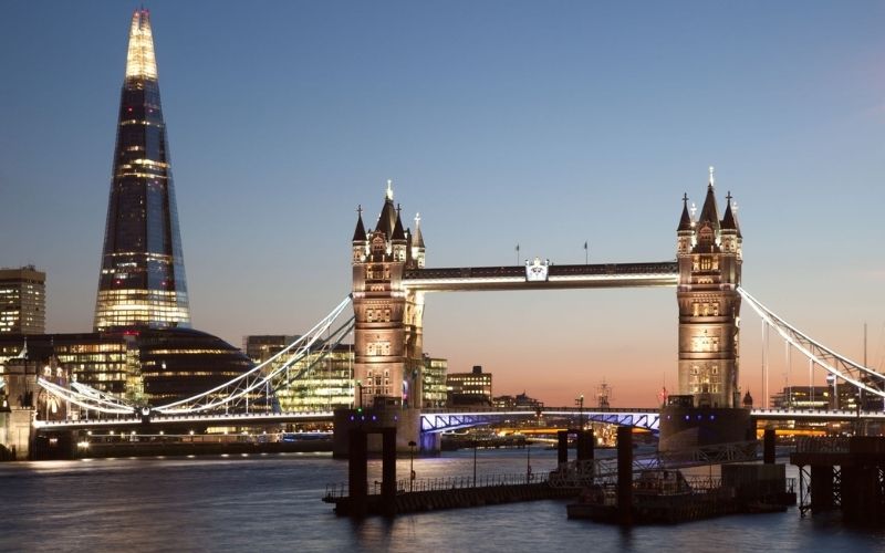 The Shard and Tower Bridge lit up at night.