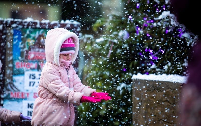 Girl playing in the snow at Santa Sleepover in Chessington World of Adventures
