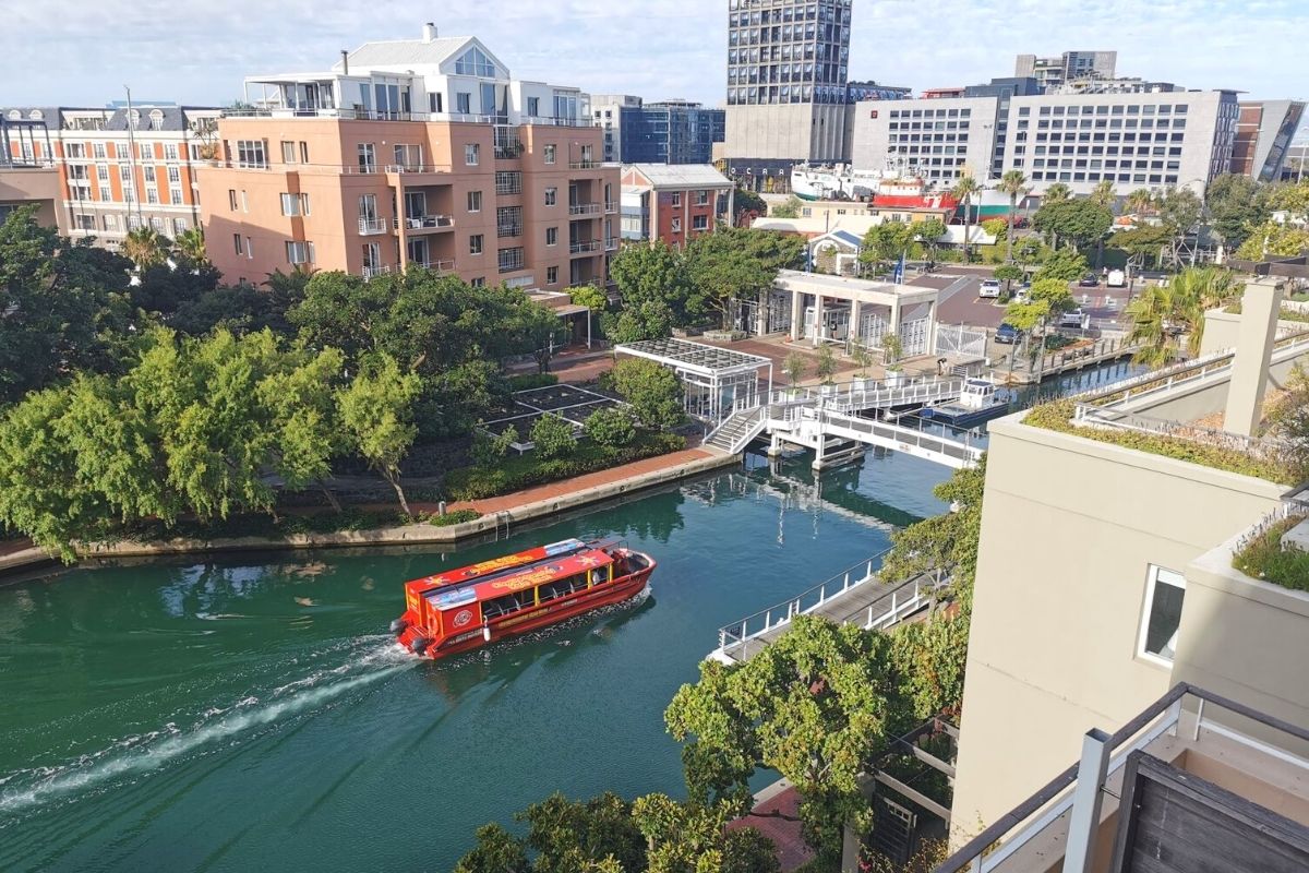 Cape Town city sightseeing boat tour passing through the canals of the Cape Town Waterfront.