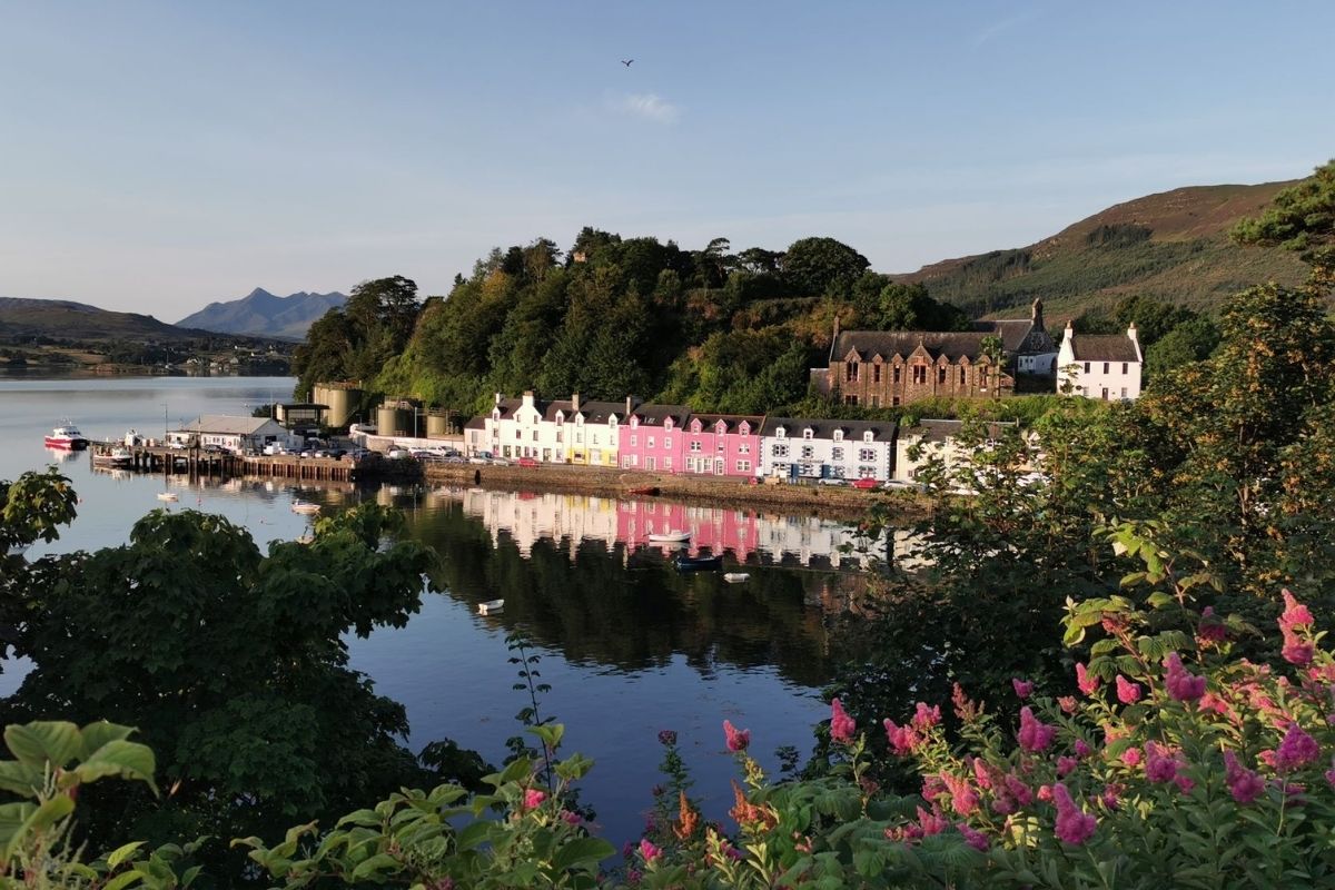 Colourful houses of Portree Harbour in the morning sun.