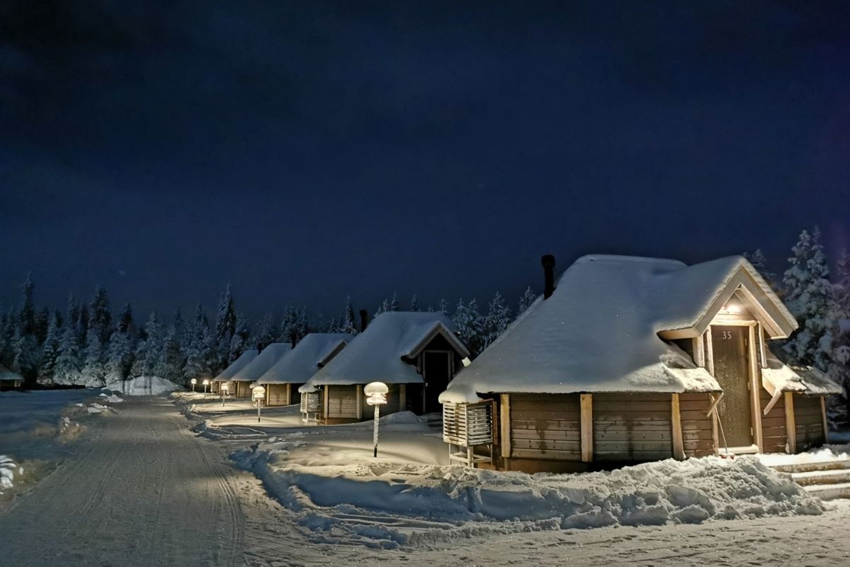 Glass igloos at Northern Lights Village Levi covered in snow.