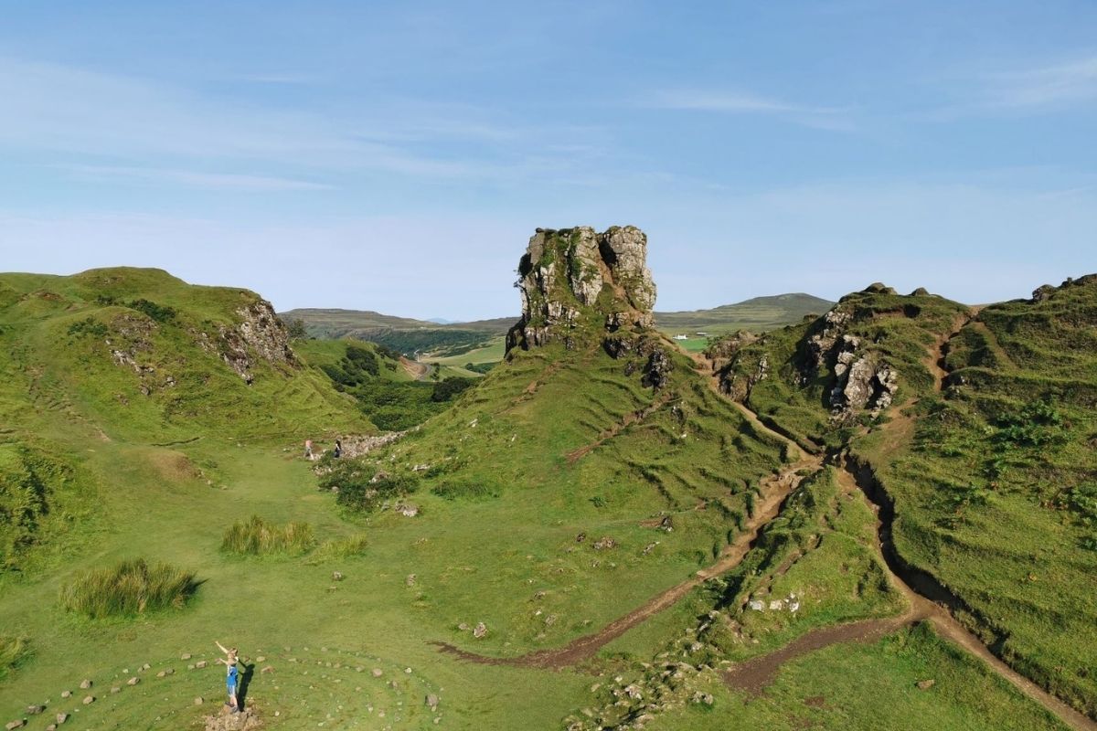 Kids standing in the stone circle of the Fairy Glen on the Isle of Skye with clear blue skies was one of the best things to do in Skye for families.