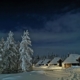 The Northern Lights Village in Levi covered in snow in the evening.