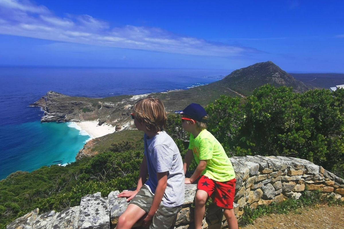 Two little boys looking out at the view from Cape Point in South Africa.