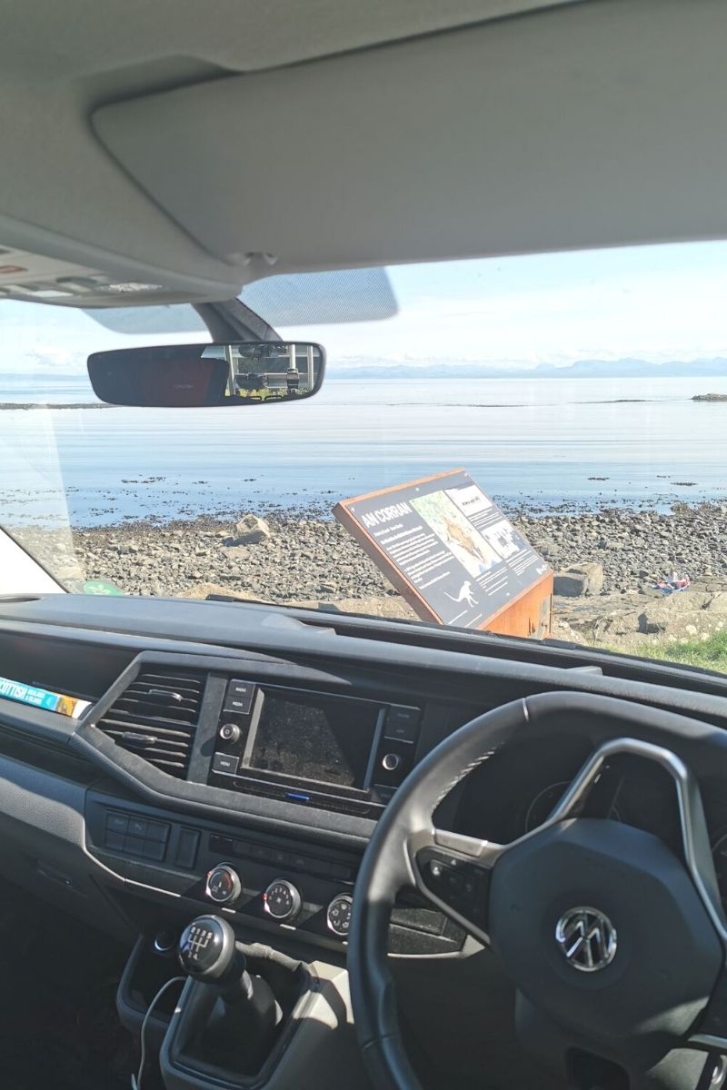 VW Campervan parked at An Corran beach overlooking Staffin Bay.