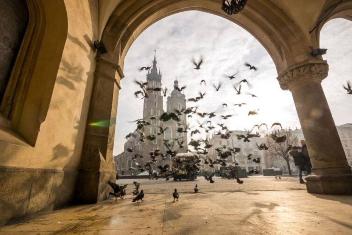 View of St Mary's Basilica from the Cloth Hall in Krakow with pigeons obscuring the view.