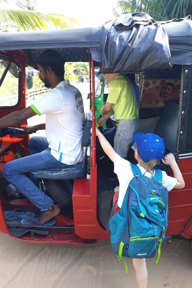 Children climbing into a tuk tuk in Sri Lanka..