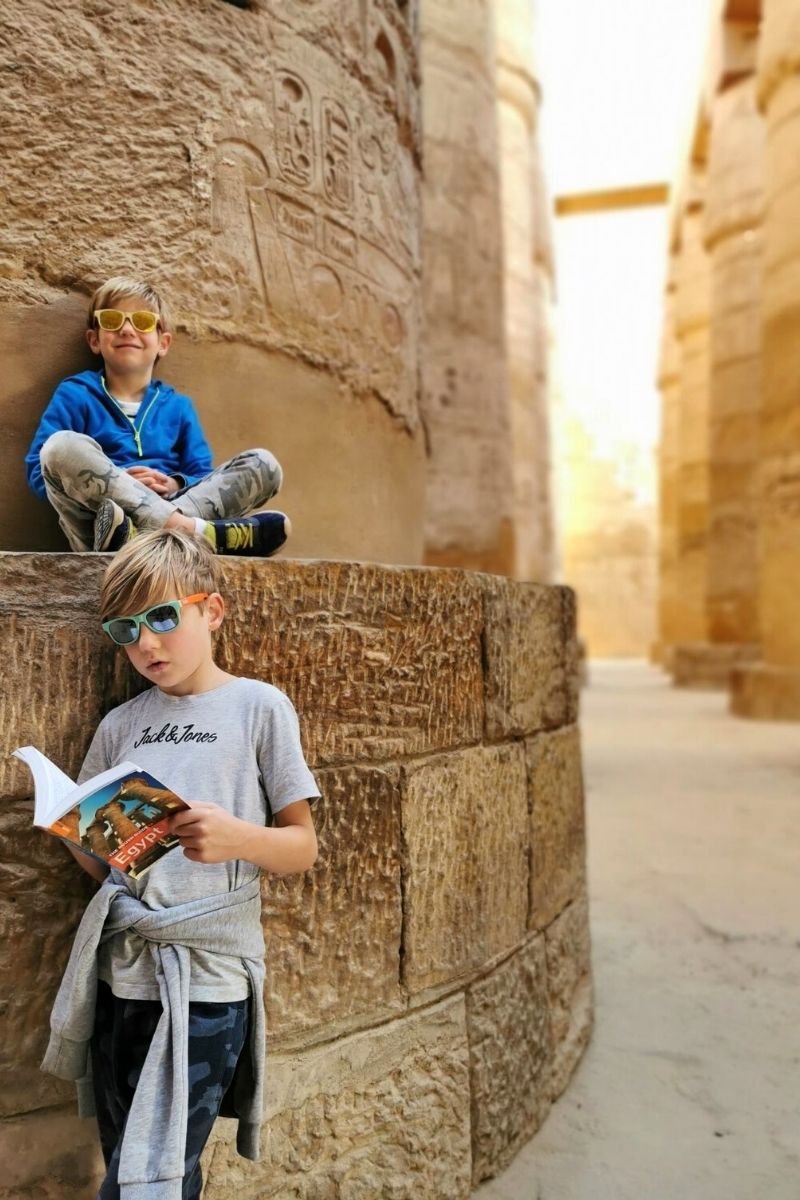 Two boys visiting Karnak Temple on our 6 day Luxor itinerary for families.
