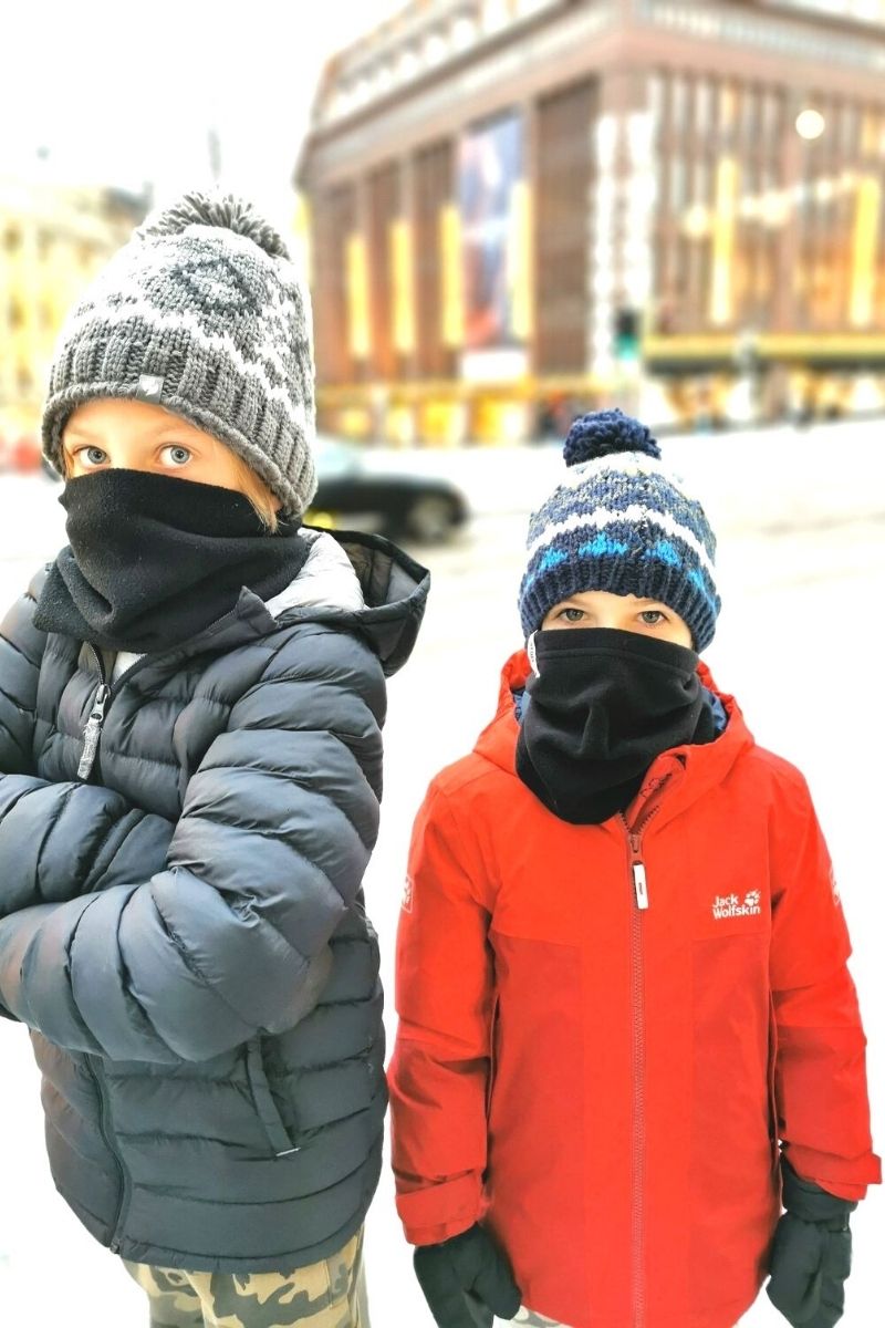 Two boys wearing a snood in cold weather.