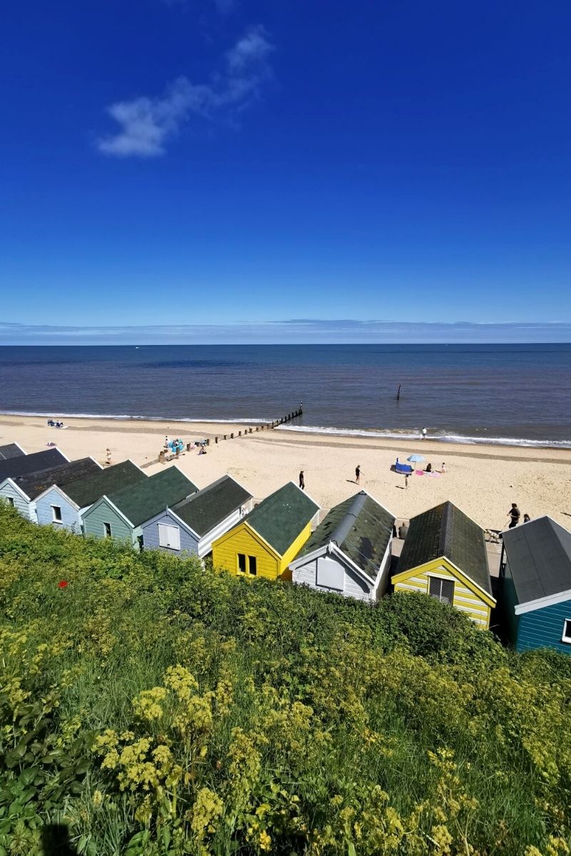 Colourful beacch huts lining Southwold beach in Suffolk.