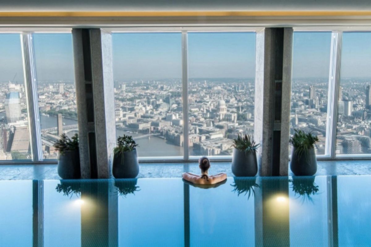 Lady in the Sky Pool at the Shangri-La at The Shard looking out over London.