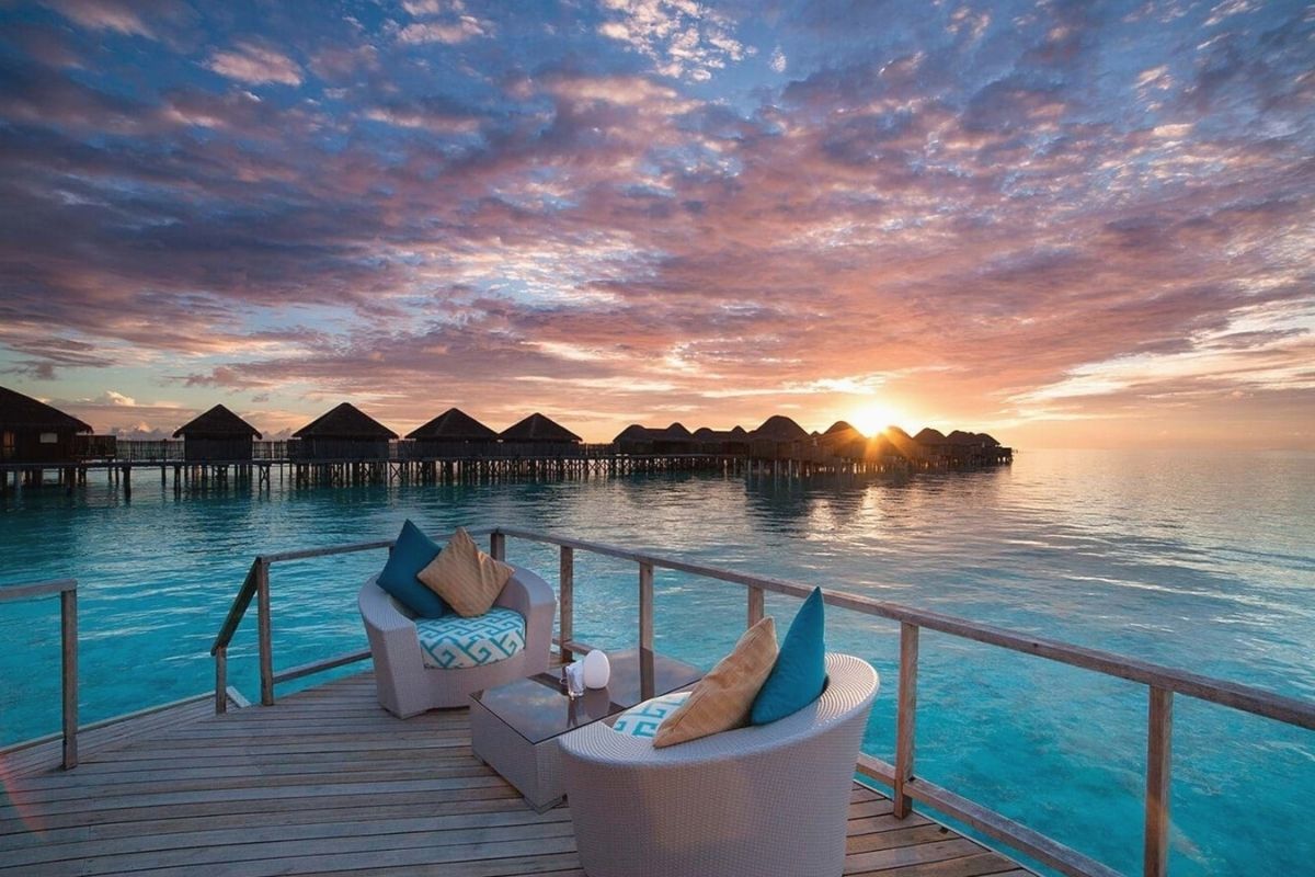 Over-water villas at Constance Halaveli in the Maldives at sunset.