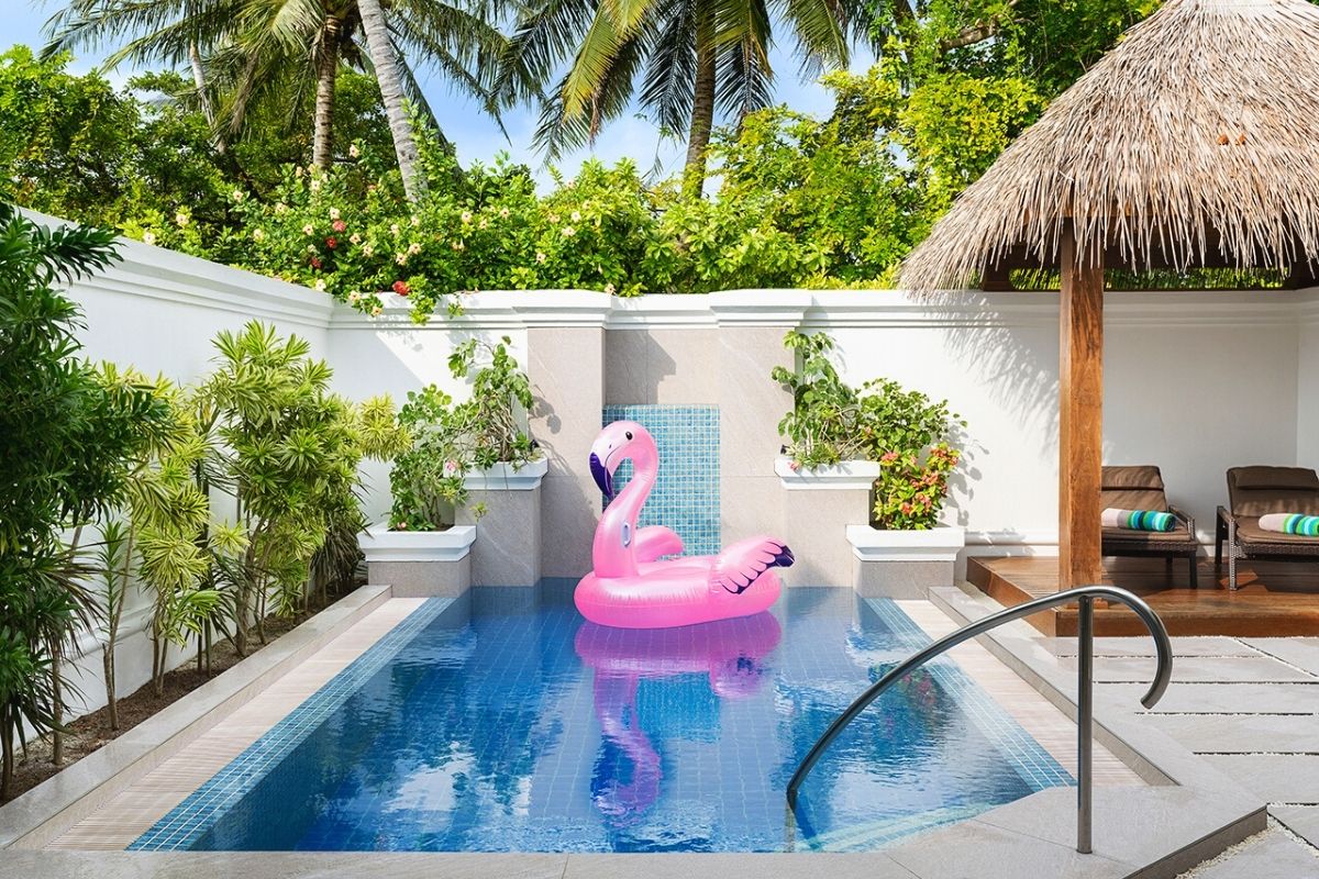 Pool area with inflatable flamingo in the pool of the Family Villa at Kurumba.