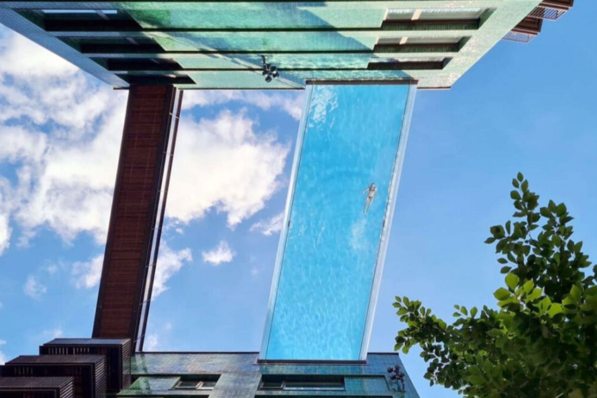 Someone swimming in The Sky Pool at Embassy Gardens in London.