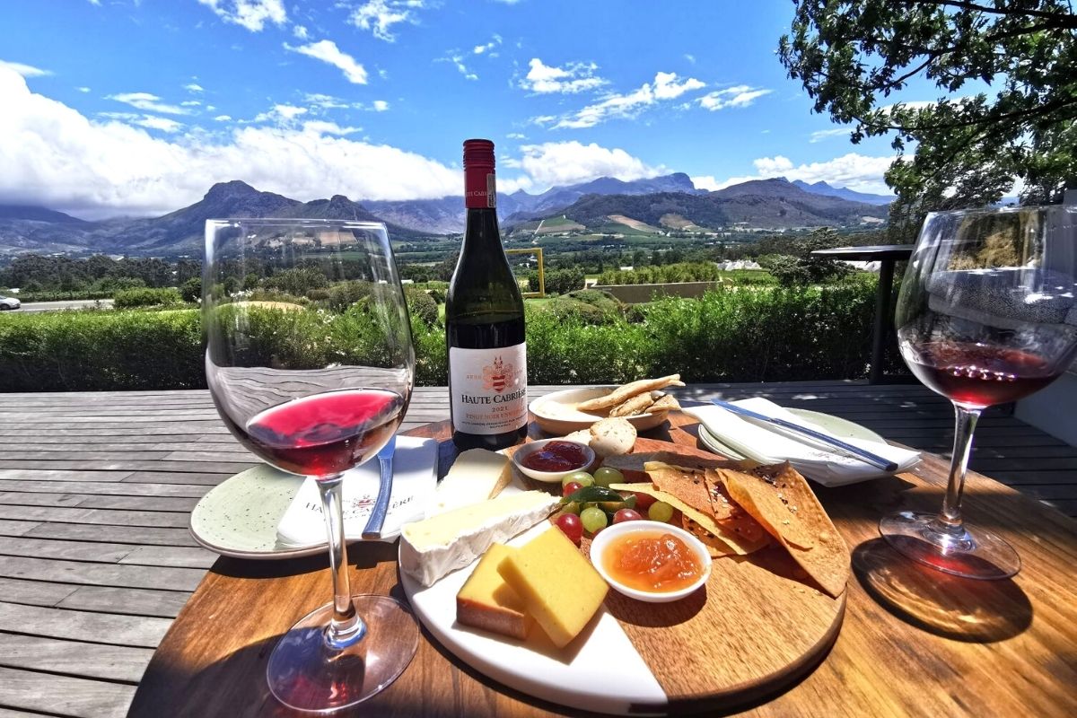 Cheese platter at Haute Cabriere wine estate in Franschhoek in South Africa with mountains in the background.