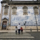 Family crossing a pedestrian crossing towards Igreja do Carmo in Porto.