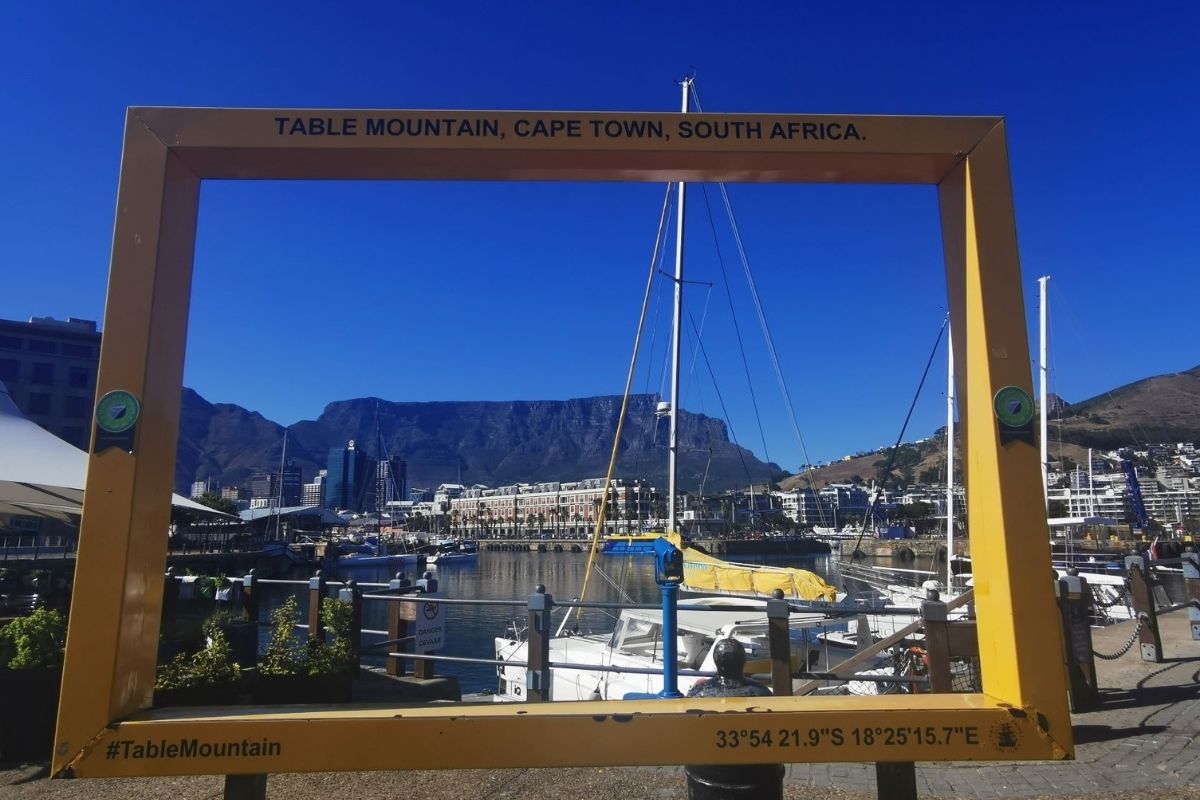 Large yellow picture frame framing the view of Table Mountain in Cape Town.