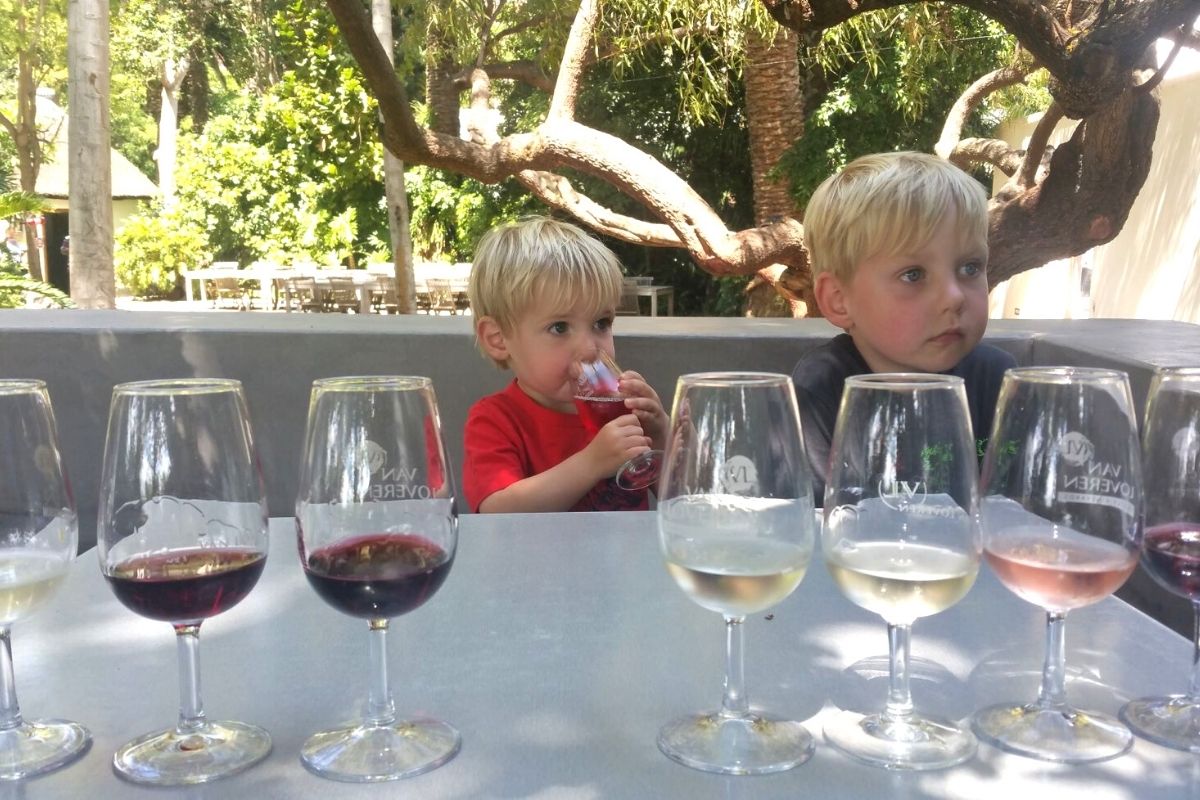 Young kids tasting grape juice at a Van Loveren Wine Estate wine tasting in South Africa.