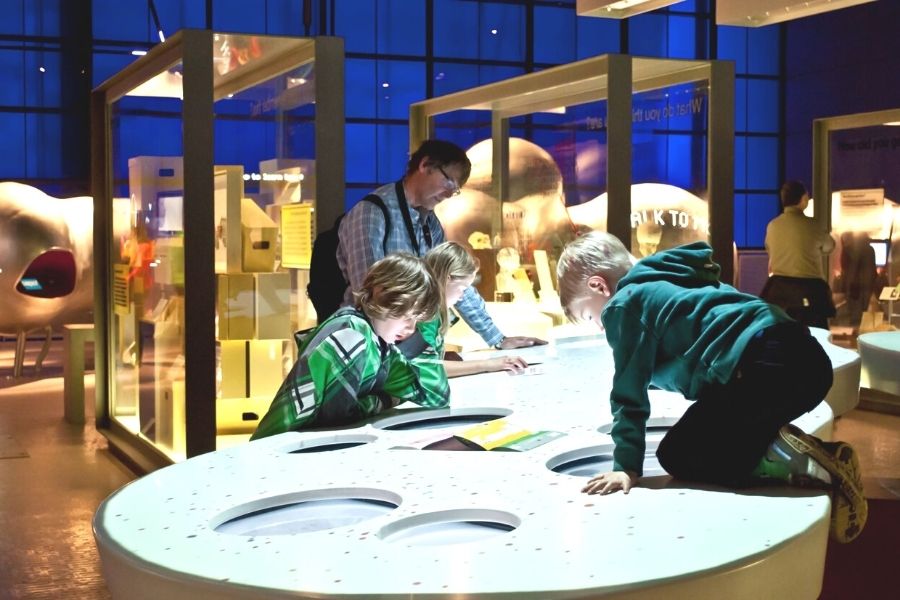 Child getting involved with an exhibit at the Science Museum in London.
