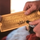 Conductor punching a Polar Express Train Ride ticket.