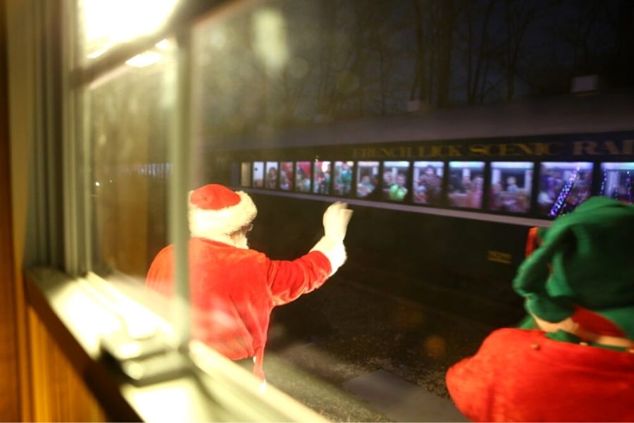 Santa waving at a train at the French Lick Scenic Railway Polar Express.
