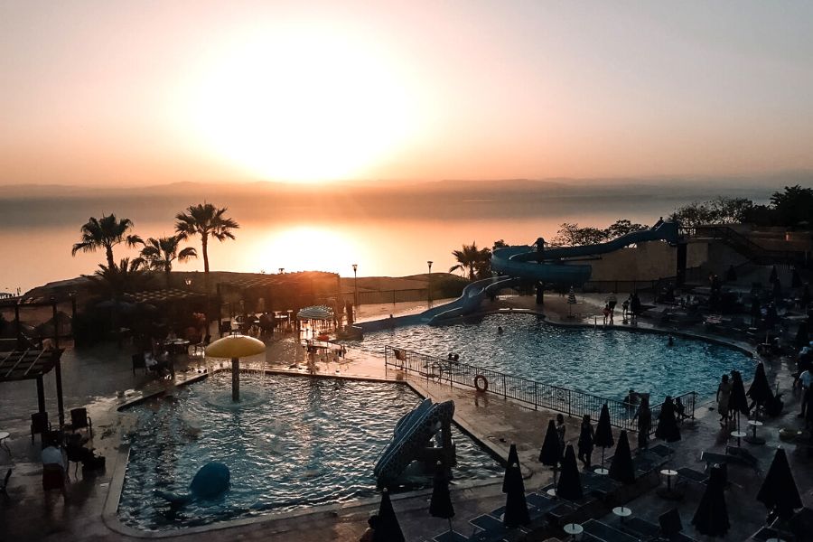 Dead Sea sunset viewed from the Crowne Plaza Dead Sea Resort with pools in the foreground.