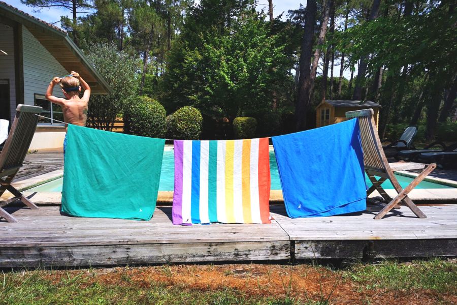 Dock and Bay towels hanging up on a travel washing line between two chairs.