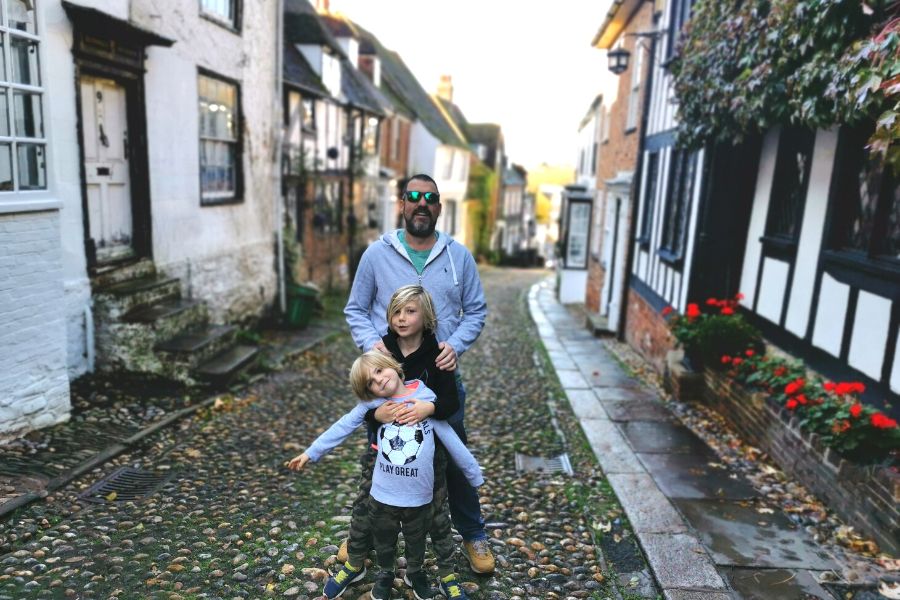 Family standing on Mermaid Street in Rye on a family day out from London.