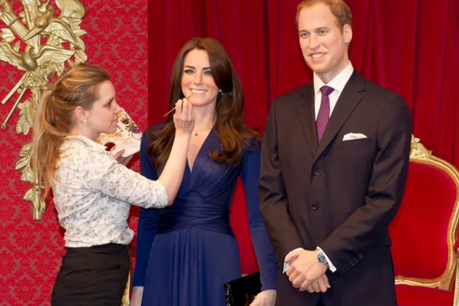 Staff member touching up the make up for the Duchess of Cambridge at Madame Tussauds in London - one of the most popular family attractions in London.