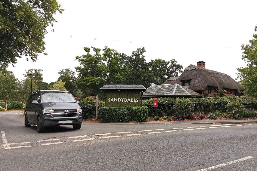 VW Campervan at the exit of Sandy Balls Holiday Village in the New Forest.