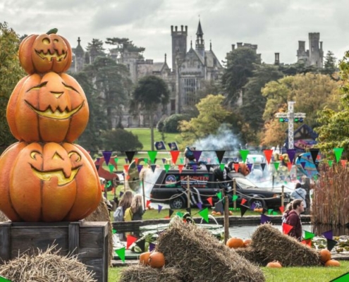 Pumpkins stacked in the foreground with Alton Towers Resort in the background at Scarefest at Alton Towers.