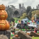 Pumpkins stacked in the foreground with Alton Towers Resort in the background at Scarefest at Alton Towers.