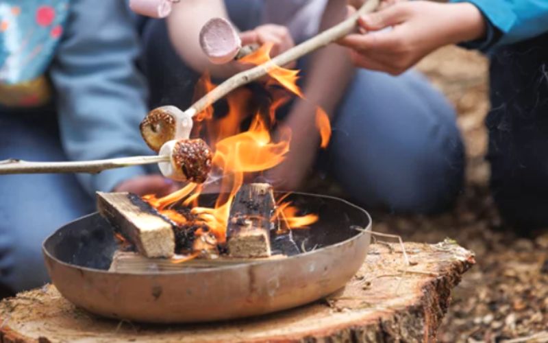 Toasting marshmallows at Forest Holidays Halloween breaks in the UK.