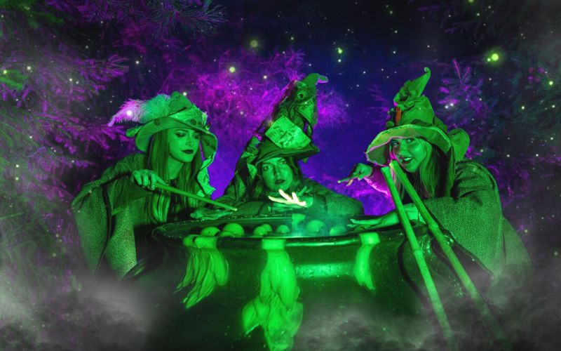 Witches around a cauldron at Howl'o'ween at Chessington World of Adventures at Halloween.